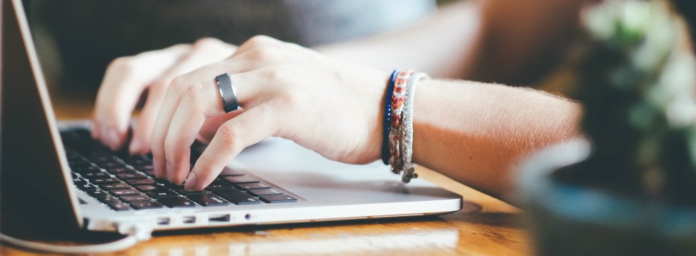 A woman typing on a laptop